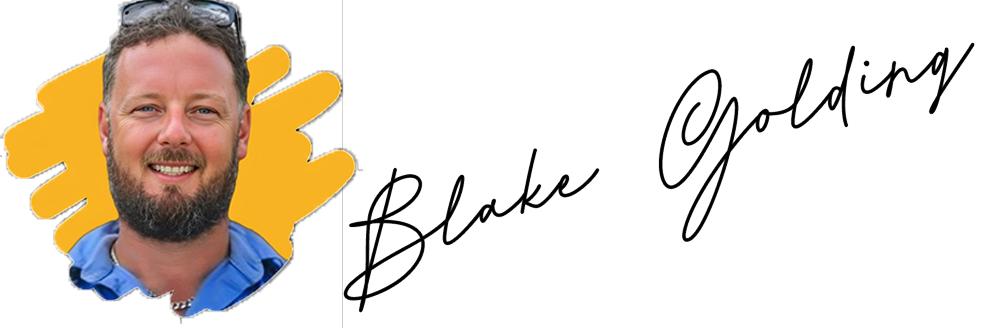 A smiling bearded man with sunglasses on his head stands before a yellow background in Cairns, near the name “Blake Golding.”.